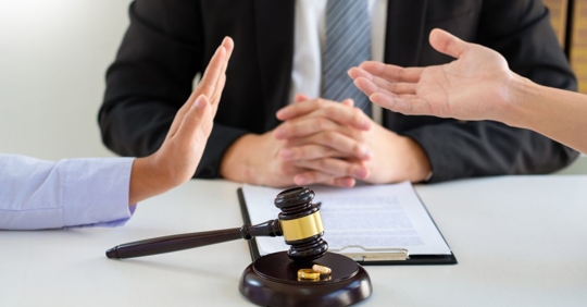 Divorcing couple debating assets with mediator