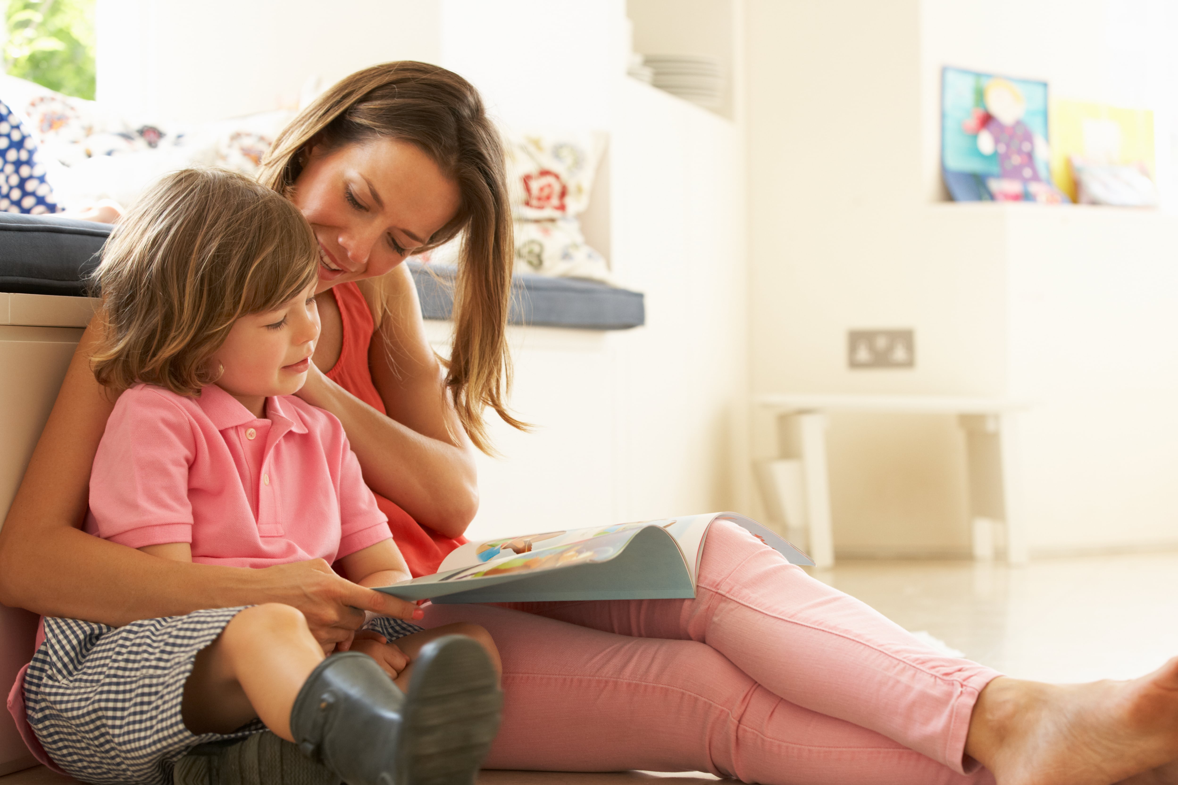 A mother reading a book with her child